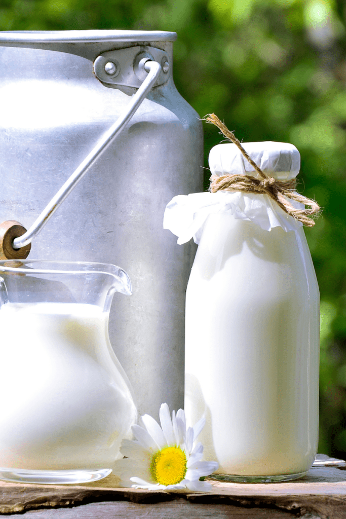glass milk jugs on table