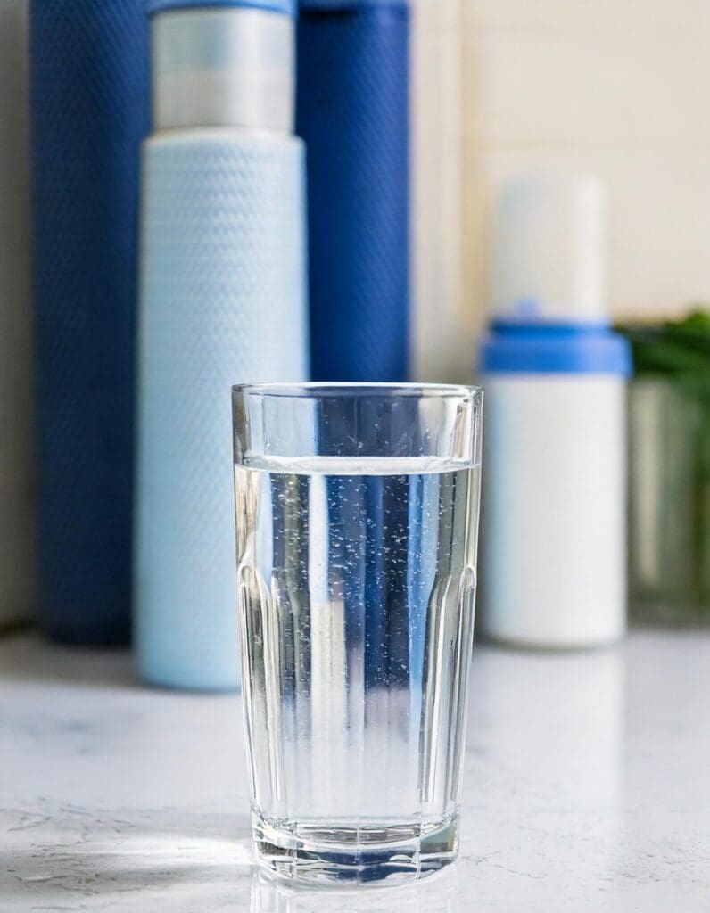 Clean Water in Glass Cup Next to Water Filters